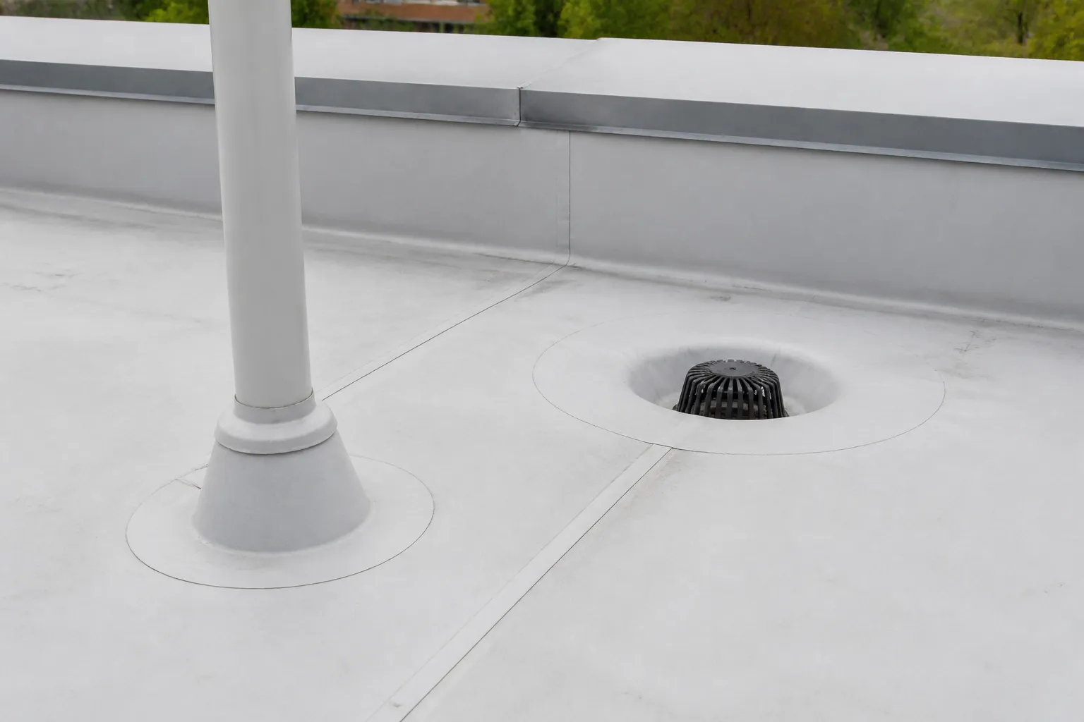 Close view of commercial roof membrane seams and penetration flashing