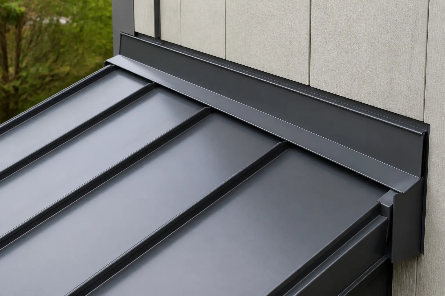 Raised standing seams meeting formed metal flashing at a roof-to-wall transition