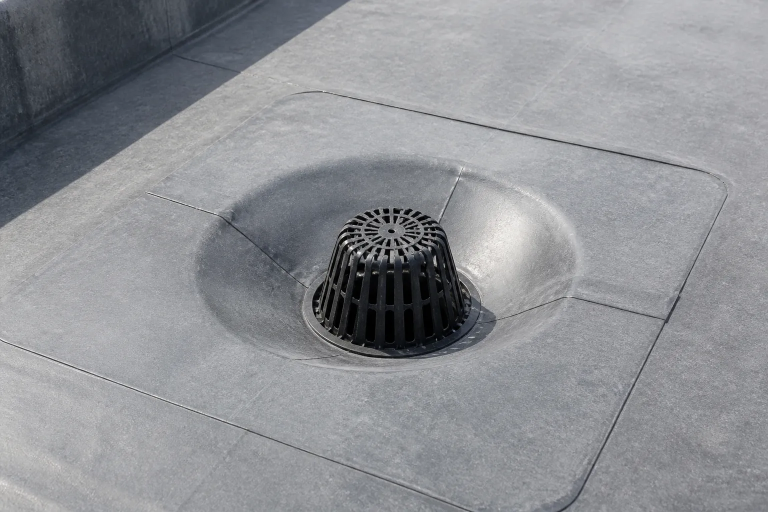 Commercial roof membrane and flashing detailed around a drainage point