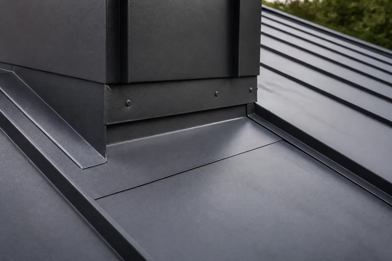 Raised standing seam and flashing transition on a metal roof panel